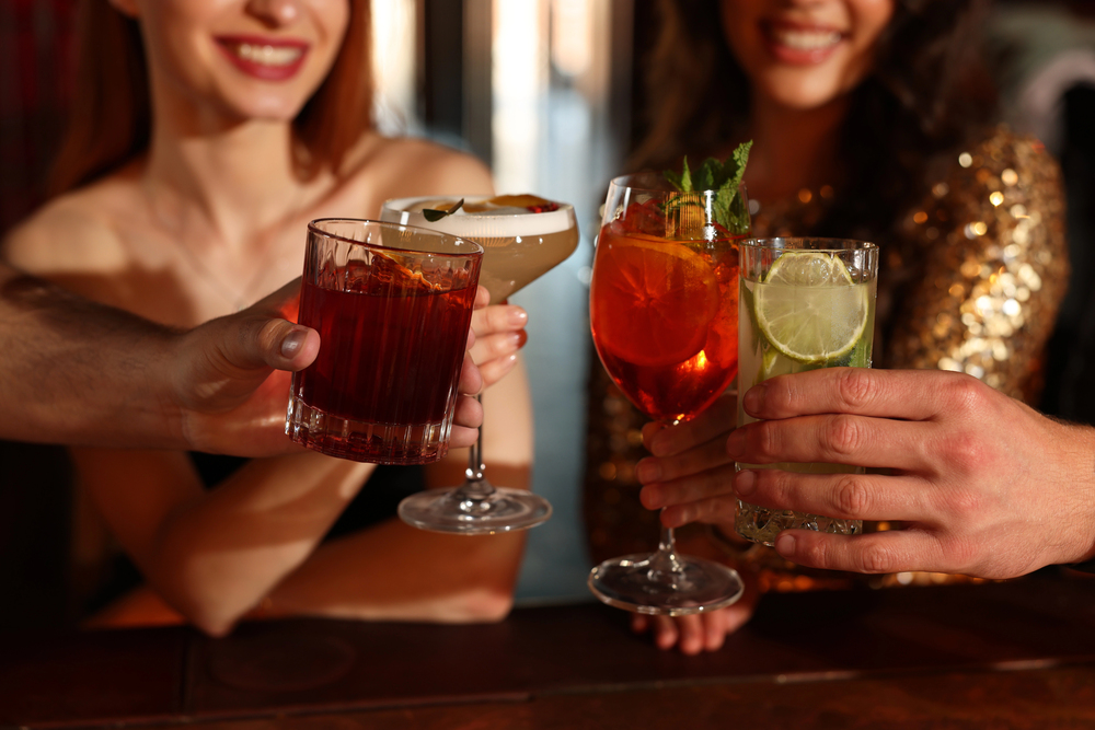 friends clinking cocktail glasses together