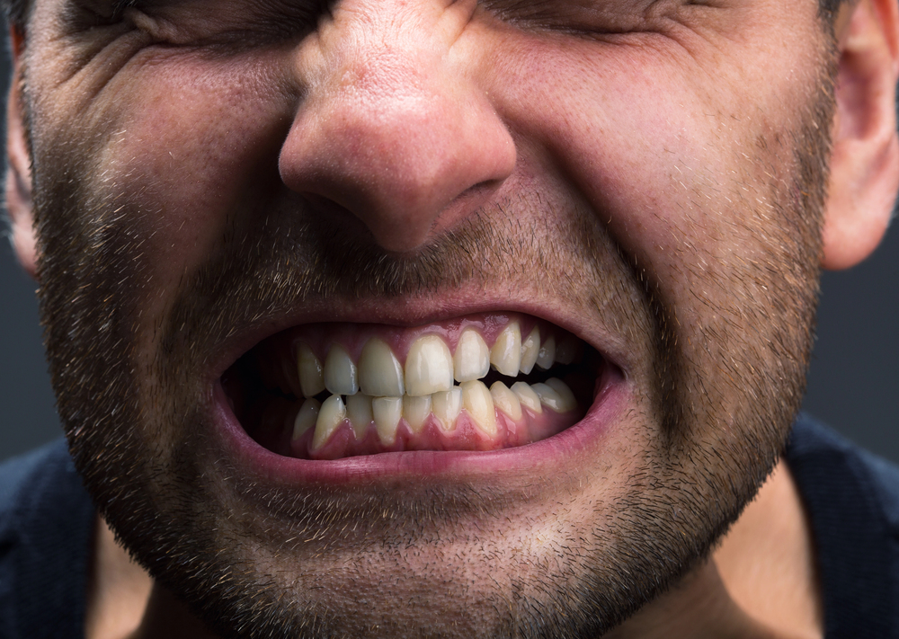 man clenching his teeth